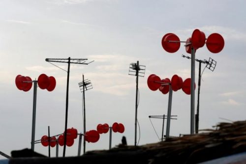 A wind power system made from plastic buckets is seen on boats at a floating village in Hanoi, Vietnam June 29, 2016. REUTERS/Kham