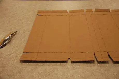 Image titled Score fold lines and cut narrow wedges at bending points.