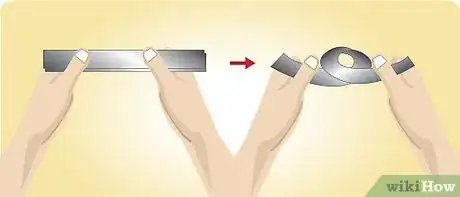 Image titled Using your hands, coil the strip into a loose ring about 4 inches wide Step 5