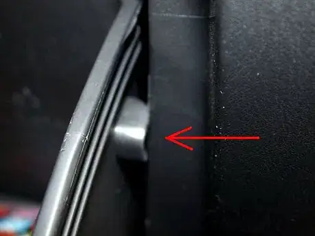 Image titled Squeeze inwards to move these tabs to the front of the dash.