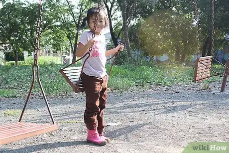Image titled Jump off a Swing Safely Step 1