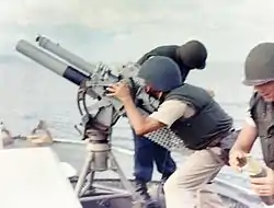 A gun crew on board USCGC&nbsp;Point Comfort&nbsp;(WPB-82317) firing an 81mm mortar during the bombardment of a suspected Viet Cong staging area one mile behind An Thoi in August 1965